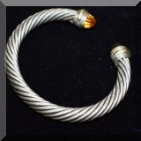 J05. Gold and sterling bracelet.